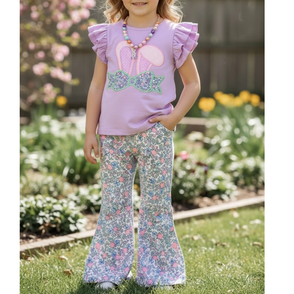 Young girl wearing a bunny ear applique top with ruffle sleeves and a coordinating floral bell bottom pant
