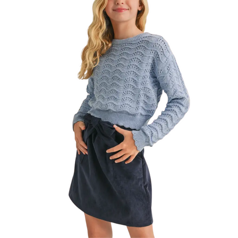 Tween girl wearing a dusty blue scalloped pointelle knit sweater with ribbed hem and cuffs.