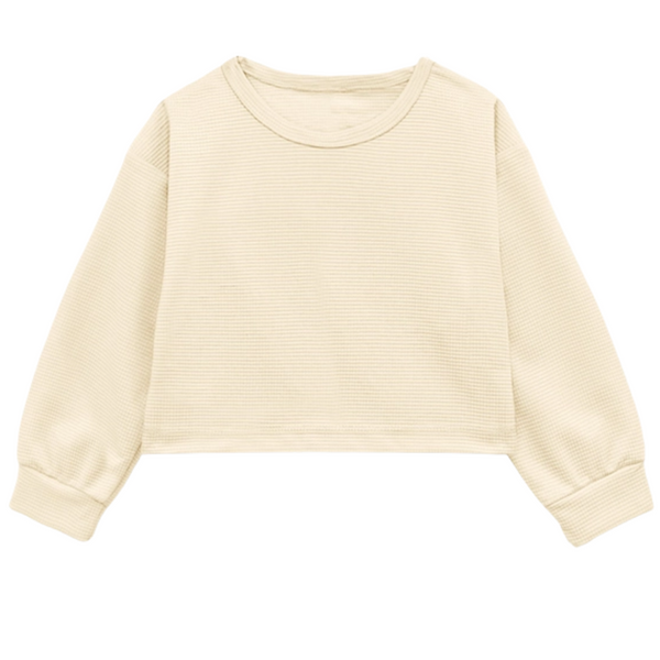 Kids’ cream waffle-knit polyester long sleeve top with ribbed cuffs and cropped fit.