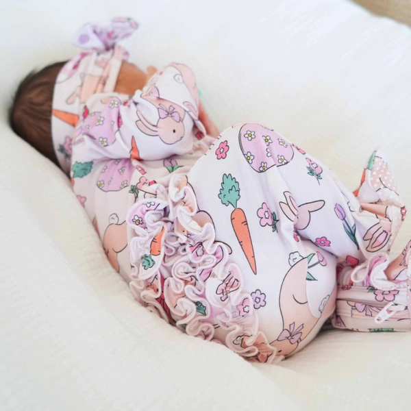baby in easter print footie showing the ruffled bum