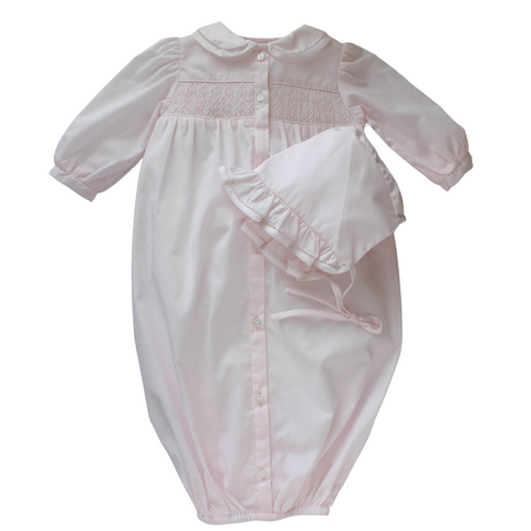 pink long sleeve gown with smocking and a matching bonnet.