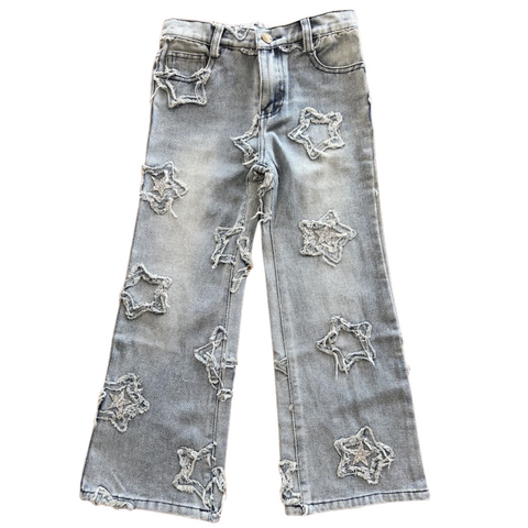 Light wash jeans with frayed star applique with same fabric and silver sequin stars placed sporadically
