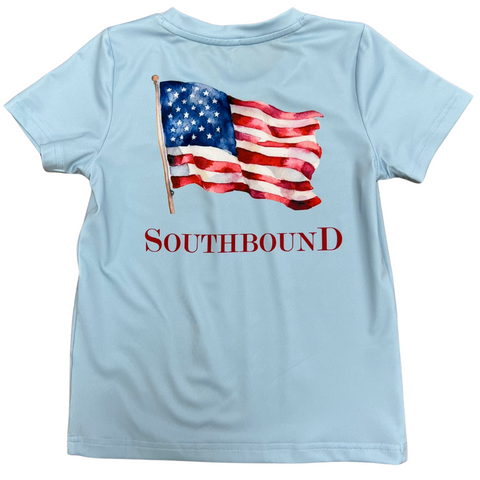 short sleeve performance fabric boy tee in light blue with an american flag graphic on the back and the southbound logo on the front left chest