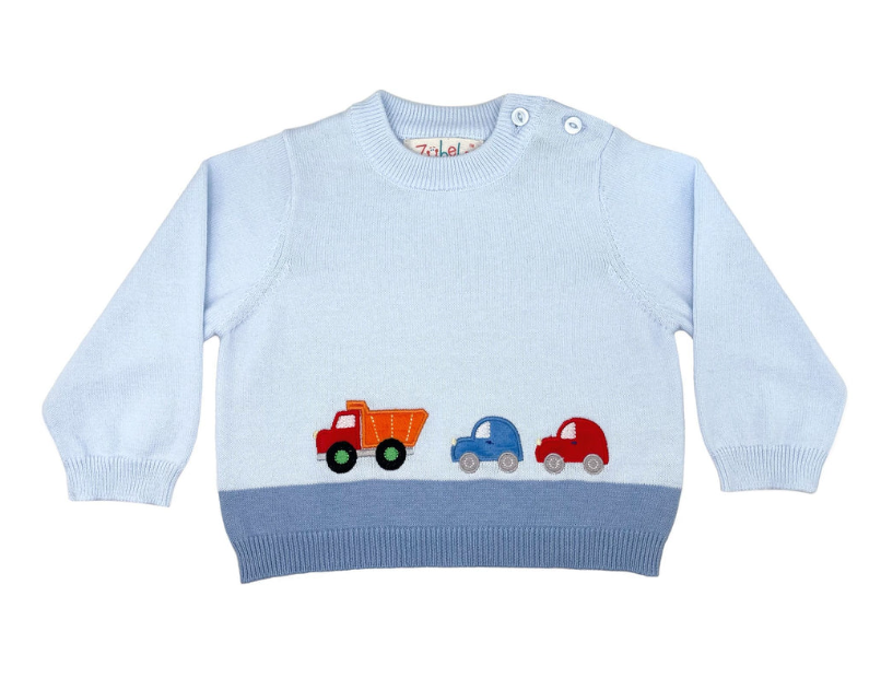 light blue sweater with three different colored cars on the sweater