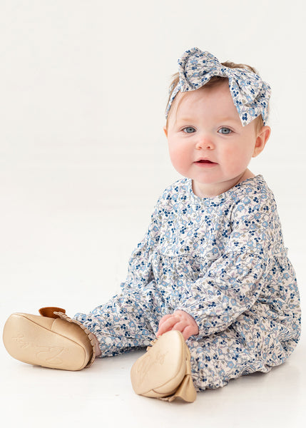 live photo of blue floral daywear romper. Hairbow not included