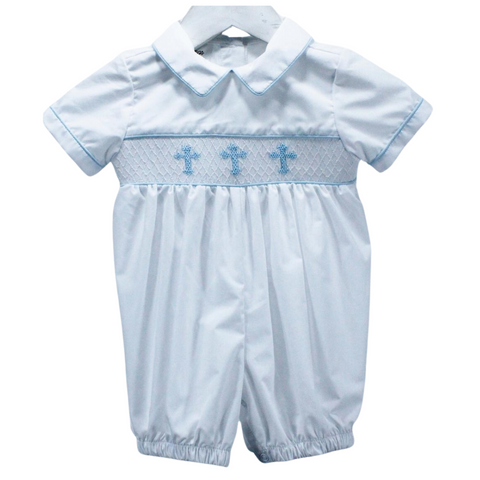 Traditional style boy romper in solid white piped at the sleeves, collar and bodice in light blue with light blue crosses smocked at the bodice.