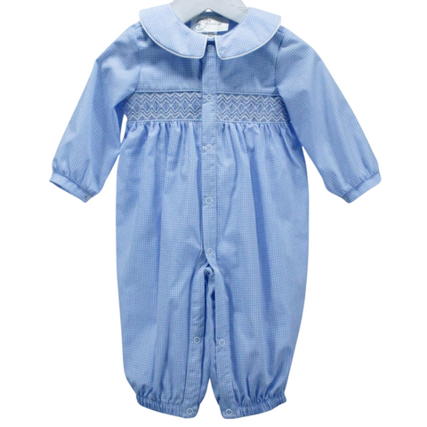 Baby boy’s long sleeve blue gingham romper with white piping on Peter Pan collar and hand-smocked geometric stitching across the chest.