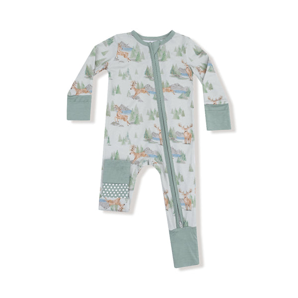 Baby romper with watercolor deer and pine tree print, green cuffs, two-way zipper, and polka dot foot and knee patches.

