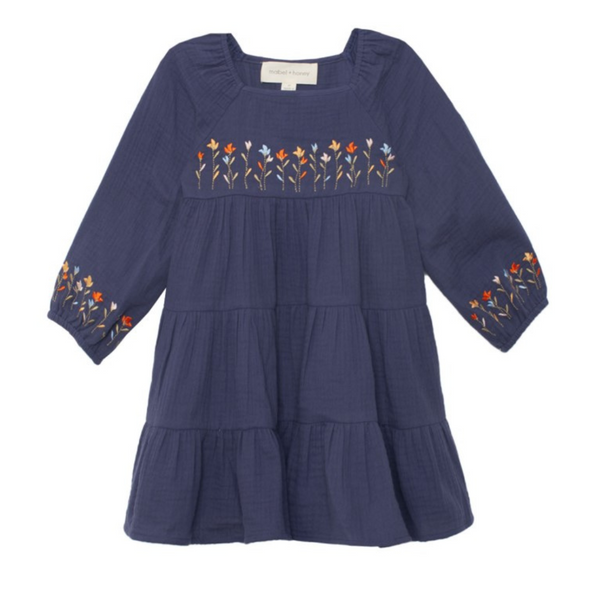 Flat lay front view of navy dress featuring floral embroidery across the chest and on puff sleeve cuffs.