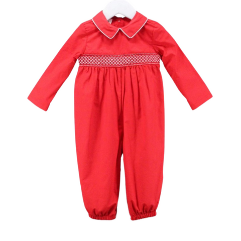 Red baby romper with long sleeves, white piped collar, and geometric smocking detail across the chest.