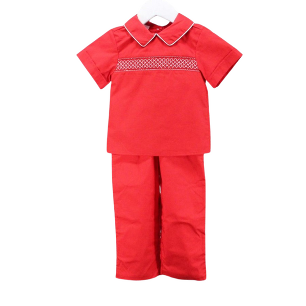 Classic red boy’s holiday outfit with smocked top and short sleeves, paired with coordinating red pants.