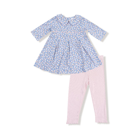 Girl’s blue floral dress with box pleats and Peter Pan collar paired with blush pink ribbed leggings featuring scalloped hems.

