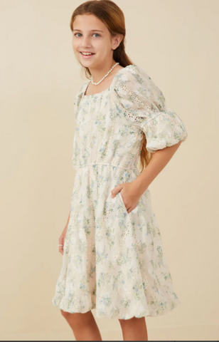 cream  with shades of blues and greens Floral elastic waist dress made with an eyelet style fabric.  Elastic waist and elastic puff short sleeve
