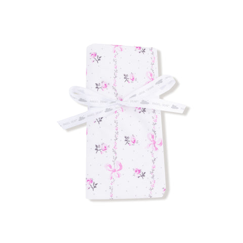 Baby blanket with soft pink interior and floral bow-printed exterior, finished with matching pink ruffle trim