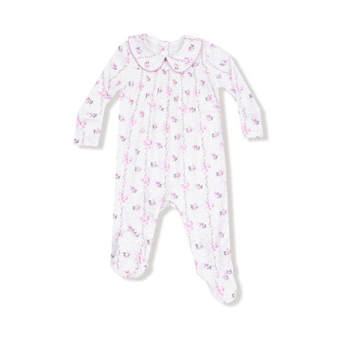 Front view of a long-sleeve baby footie with pink bow stripe print, smocked chest, and Peter Pan collar with pink trim