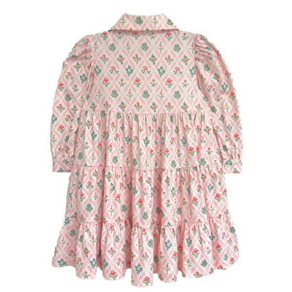 Back view of a pink floral tiered dress with puff sleeves and Peter Pan collar, laid flat on white background.