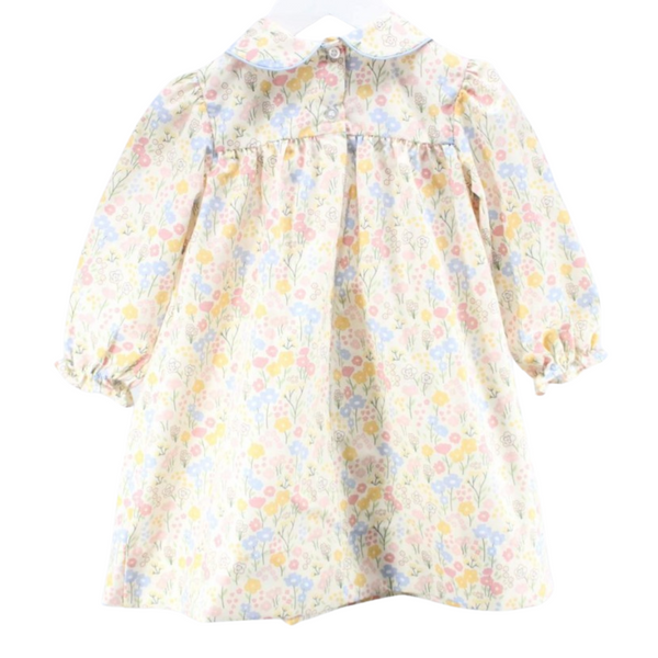 Back view of the same floral dress showing gathered detailing and a button closure.