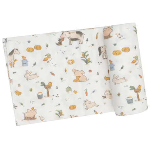 white swaddle blanket with farm animals like horses, chickens, roosters, and pigs