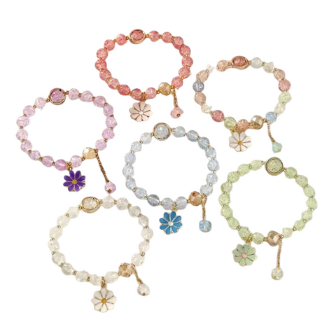 A product image showing six individual, circular coils of flower pendant glass bead bracelets arranged in two rows of three against a white background. The bracelets come in various colors including pink, purple, blue, green, and clear, with each featuring a small enamel flower charm and a dangling glass bead.