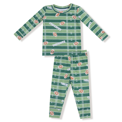 Green kids' pajama set with football field and football print, featuring glow-in-the-dark elements on top and pants.








