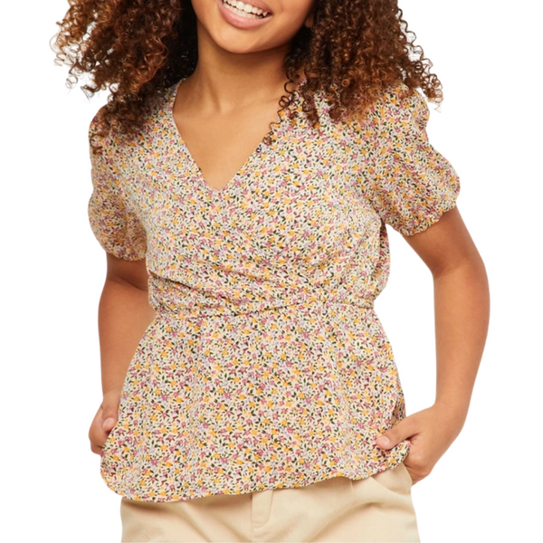 Girl in blush floral puff sleeve top with V-neck and smocked waist