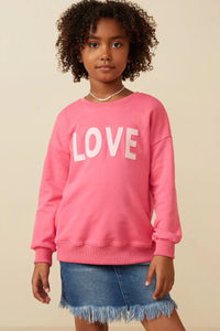 Long sleeve pink top with LOVE patch on it