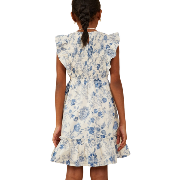 Back of girls’ blue floral dress with smocked bodice and ruffle sleeves
