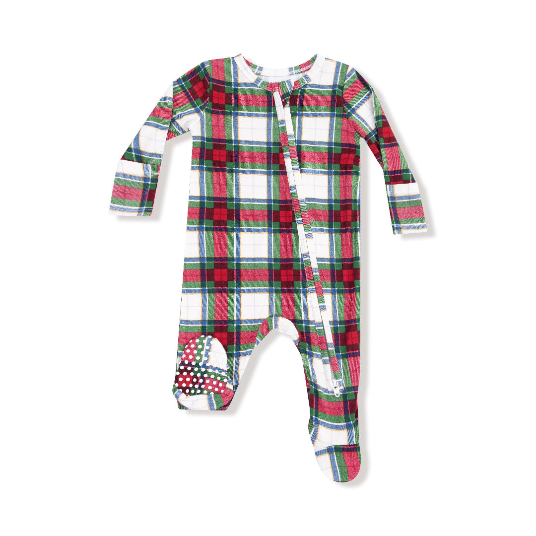 Holiday plaid baby footie with green, red, and blue check pattern and non-slip soles.

