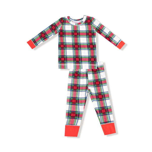 Children’s holiday plaid loungewear set with red, green, and white pattern, long-sleeve top, and matching pants with red cuffs.
