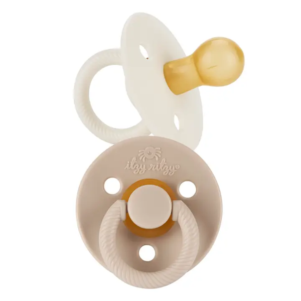 Itzy Ritzy soother pacifier in neutral Coconut and Toast colors with natural rubber nipple and textured ring handle.