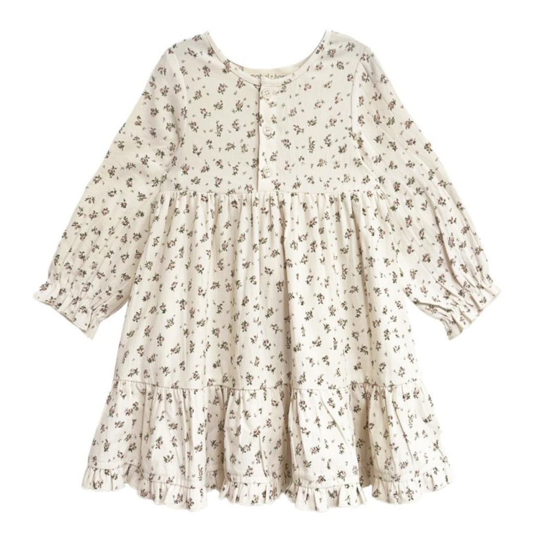 Front view of a long sleeve floral girls’ dress with buttons and gathered waist.