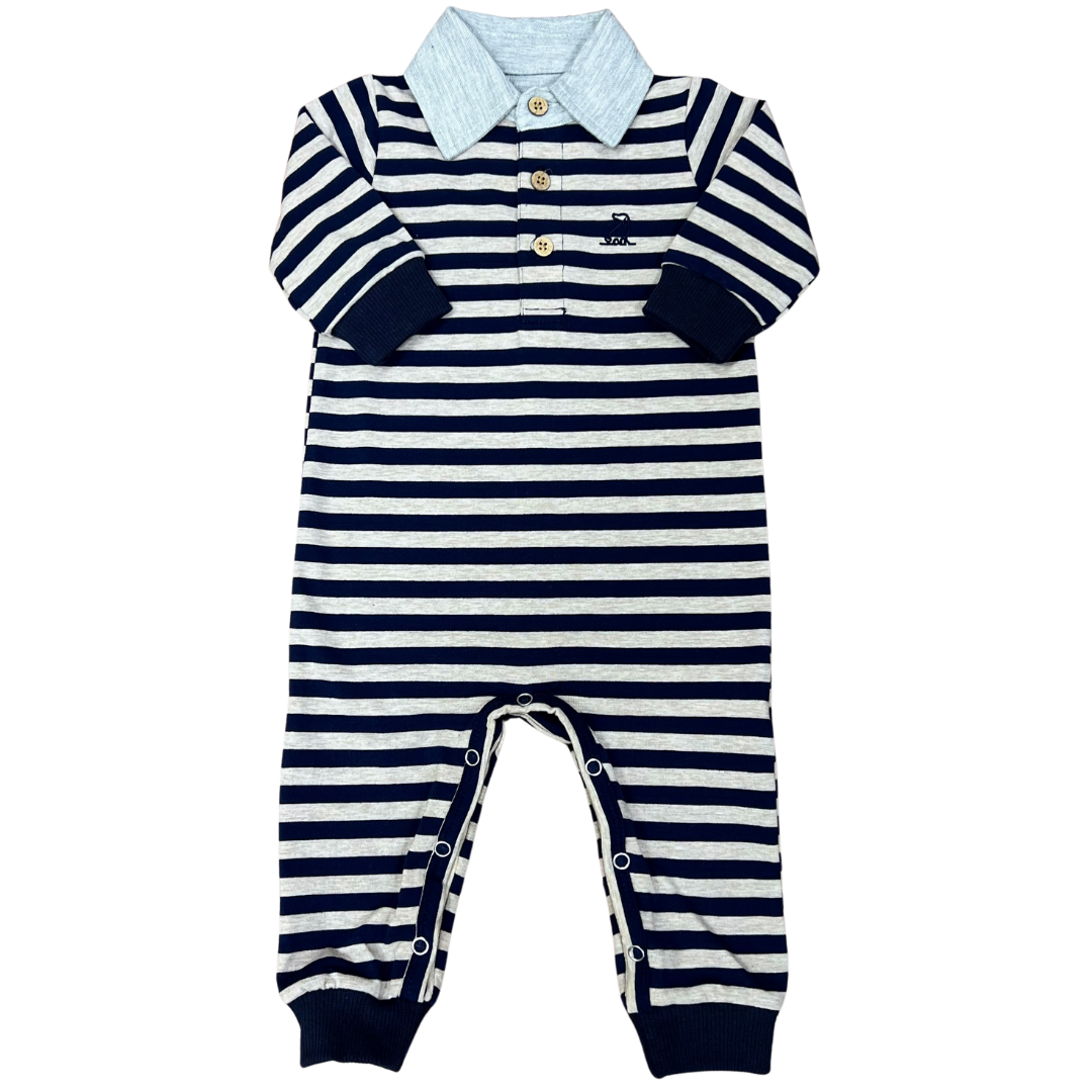 navy and beige all in one polo romper with solid navy sleeve and leg cuffs and beige polo collar.  Three button front and snap bottom closure