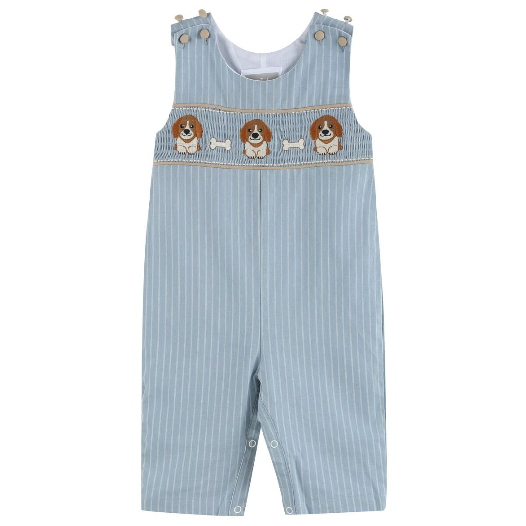 Light blue pinstripe baby boy overalls with smocked chest featuring embroidered puppies and white bones; button straps and snap legs visible.