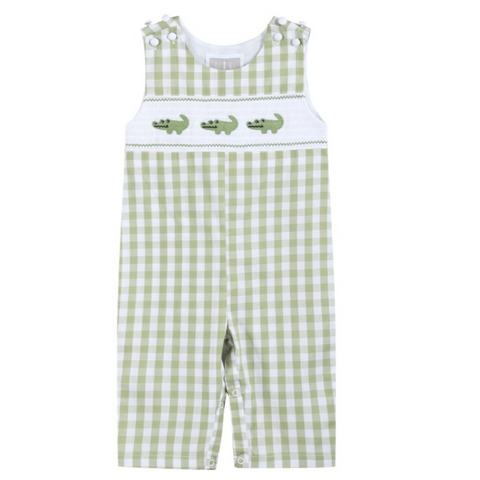 Front view of light green gingham baby overalls with three embroidered alligators on a white smocked chest panel and snap closures on the shoulders and legs