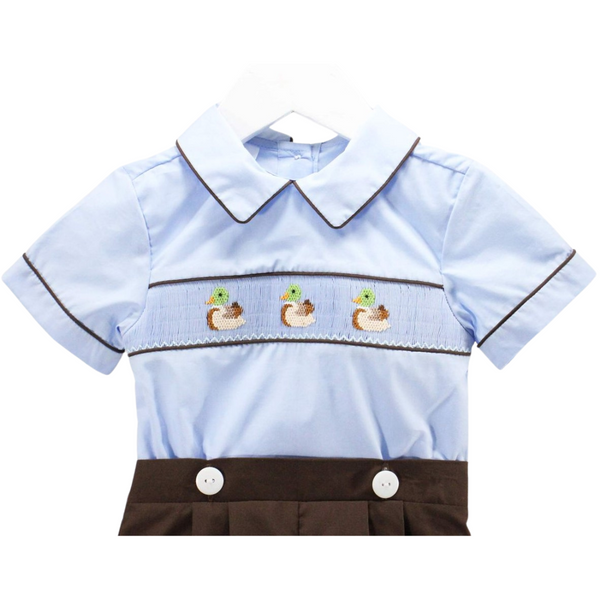 Close-up of duck embroidery and piping detail on the collar and sleeves