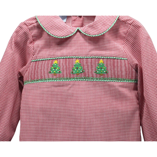 Close-up of the red gingham shirt’s chest area, highlighting the hand-smocked Christmas tree embroidery with green and yellow detailing.

