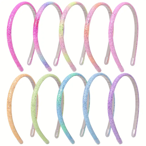 A grid of ten thin headbands, each featuring a different ombre glitter color transition. Colors include blends of pink, purple, yellow, green, blue, and orange.