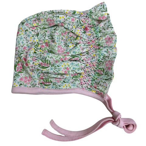 Hand smocked baby bonnet in a sweet florlal print and pink trim and ties