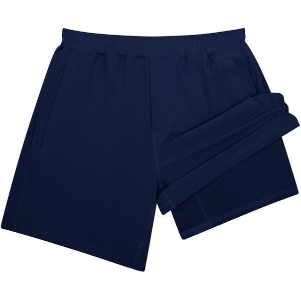 Boys solid navy blue athletic shorts with elastic waistband and side pockets displayed on white background.