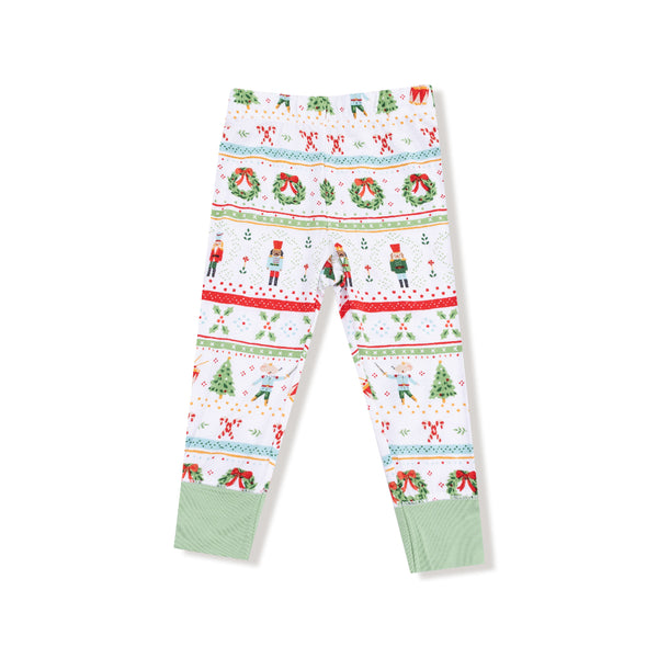 Back view of holiday pajama bottoms featuring nutcracker and Christmas tree print with green ankle cuffs