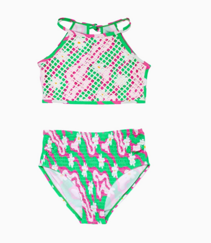 halter necklace style swim top in a pink and green geometric and floral pint covered in a white mesh with same print smocked bottoms