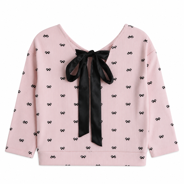The back of a pink sweater with black bows and one big black bow