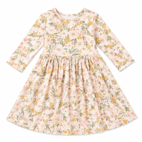 A sweet girls dress with blush floral long sleeve twirl dress while holding a pink handbag, featuring yellow and sage watercolor flowers.