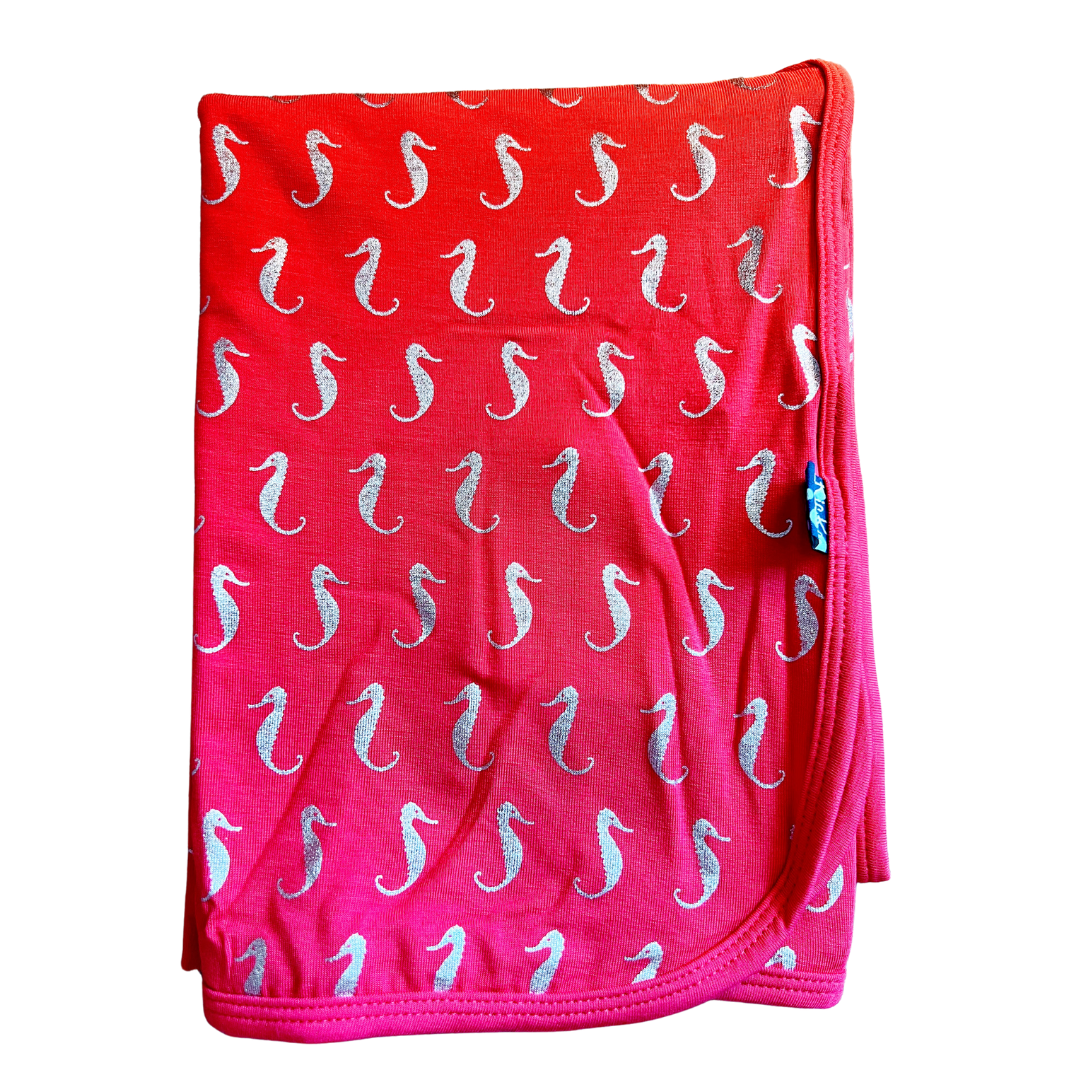 bamboo swaddling blanket in darker pink color with small  sparkle seahorse print