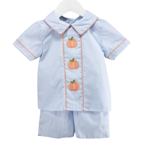 Front view of a boy's light blue gingham outfit with short sleeves and three orange embroidered pumpkins down the front.