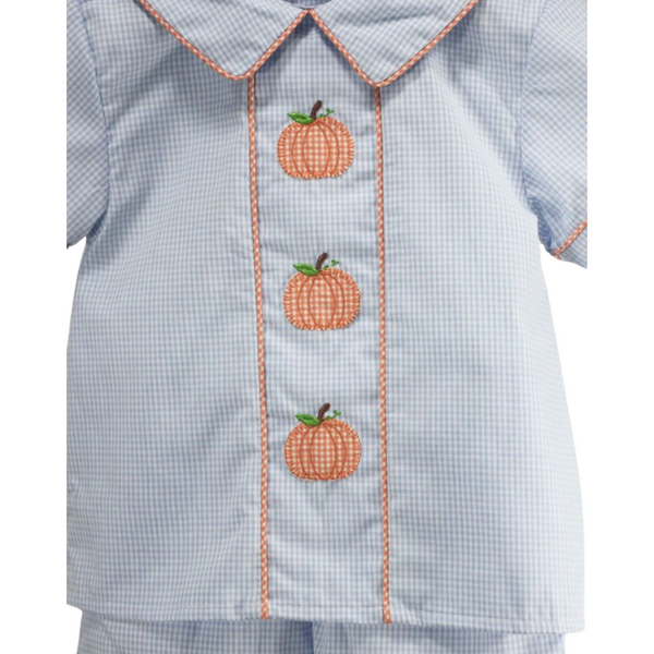 Close-up of the embroidered pumpkins and orange trim on the front of the light blue gingham shirt.