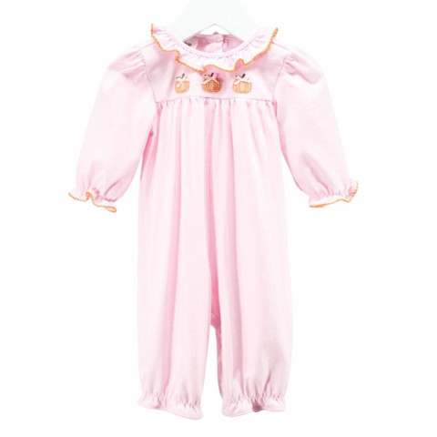 Front view of a pink long sleeve romper featuring three orange gingham pumpkins embroidered across the chest and orange ruffle trim on the collar and cuffs.