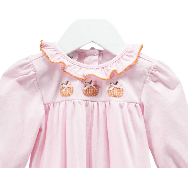 Close-up of the neckline and embroidered pumpkins on the pink romper, highlighting the orange gingham pattern and tiny pink bows on the pumpkins. 