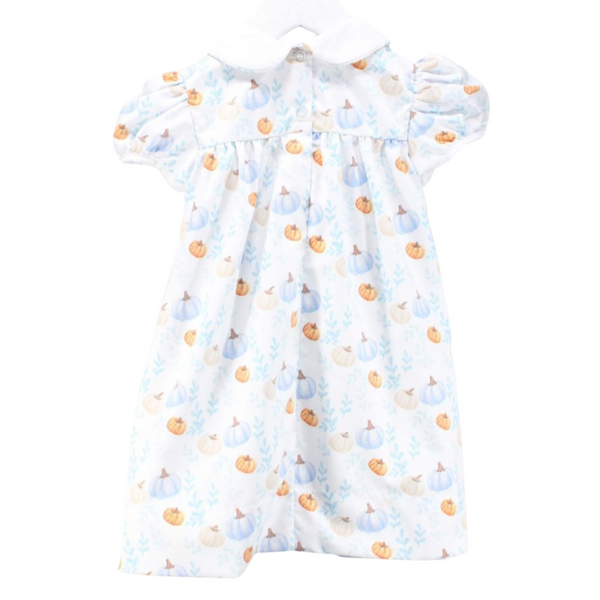 Back view of the same pumpkin-themed dress, showing the button closure and soft gathers for fullness.