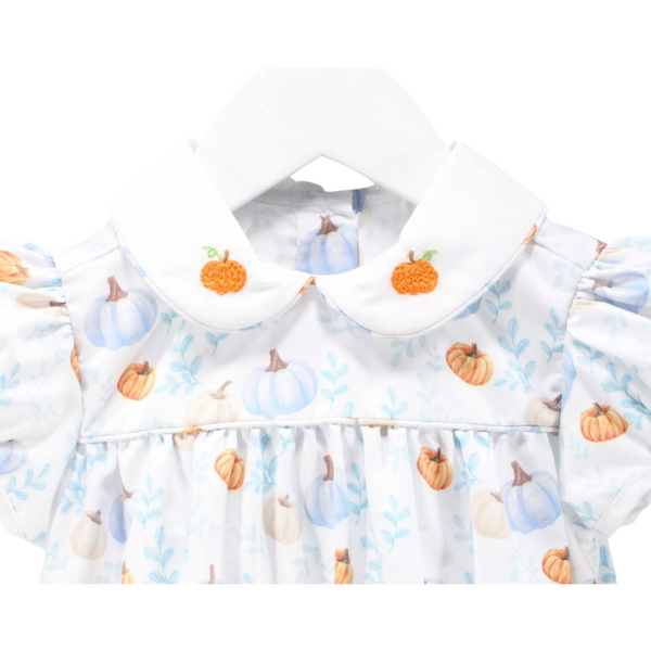 Close-up of the dress collar showing embroidered orange pumpkins on a white Peter Pan collar, with pastel pumpkin print fabric below.